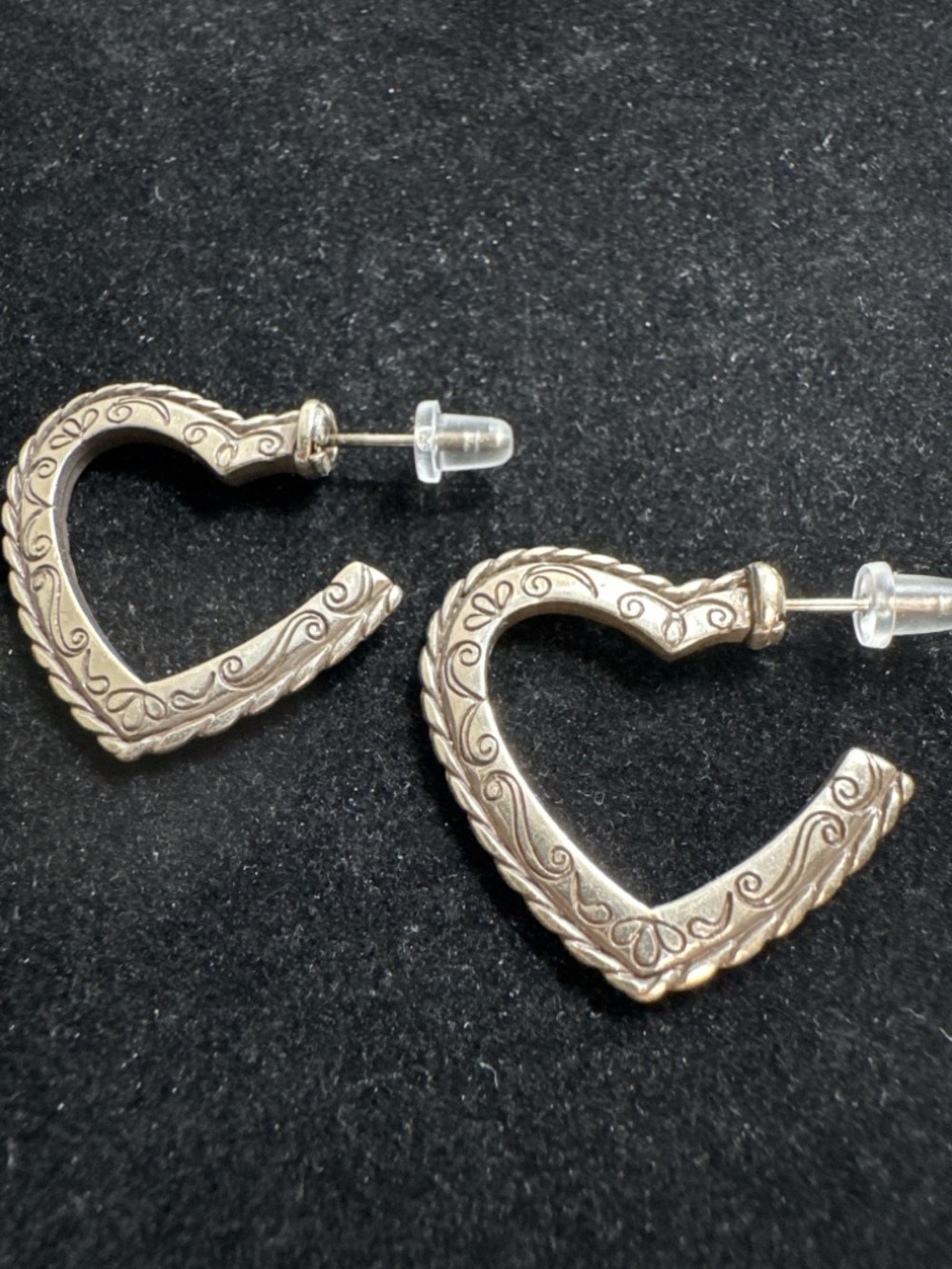 Brighton-style silver scroll heart dangle earrings, intricate engraved designs.